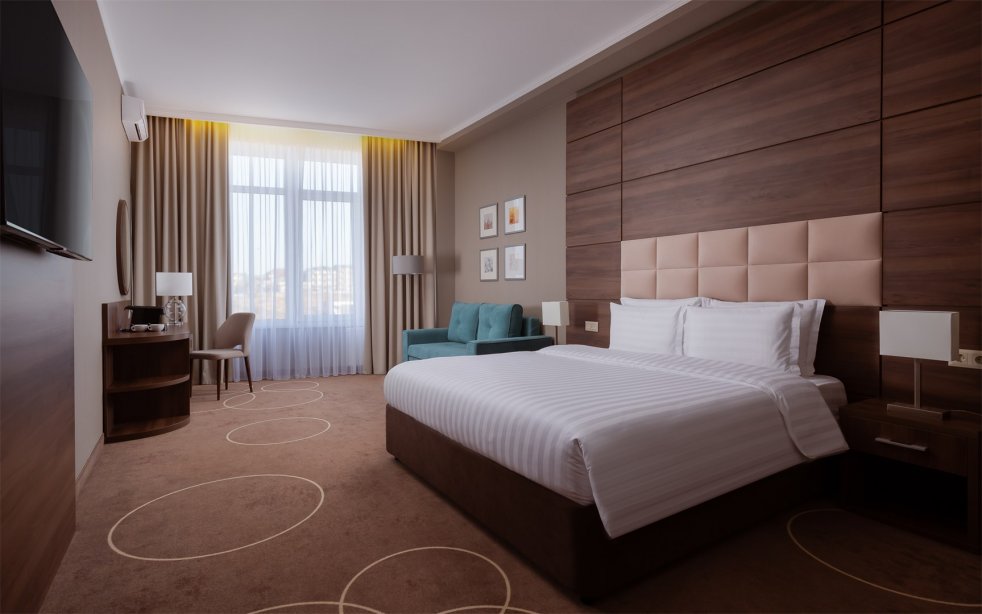 Junior Room with a large double bed and sofa